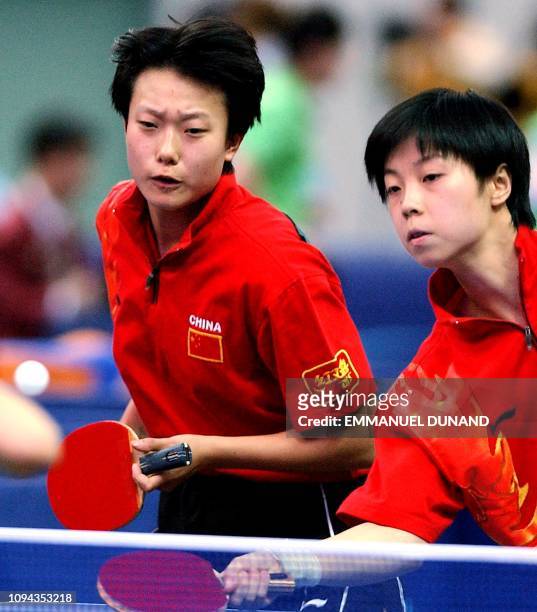 Chinese table tennis players Zhang Yining and Li Nan returns the ball 07 october 2002 during their semifinal match against South Korea's pair Ryu Ji...
