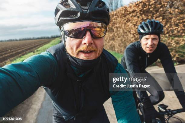 winter cycling selfie - friends cycling stock pictures, royalty-free photos & images