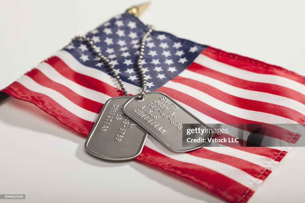 Army dog tags on Stars and Stripes flag