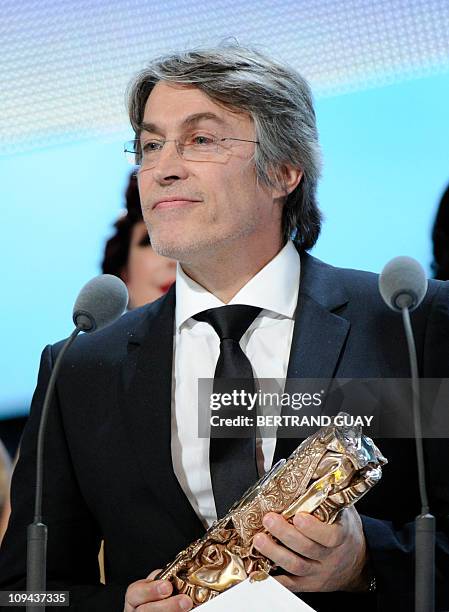 French set designer Hugues Tissandier celebrates after winning the Best Production Designer award for French director Luc Besson's film "Les...