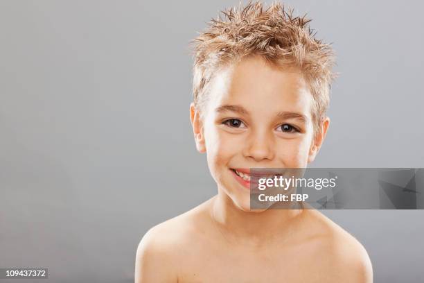 studio portrait of toothless boy (8-9) smiling - spiky hair stock pictures, royalty-free photos & images