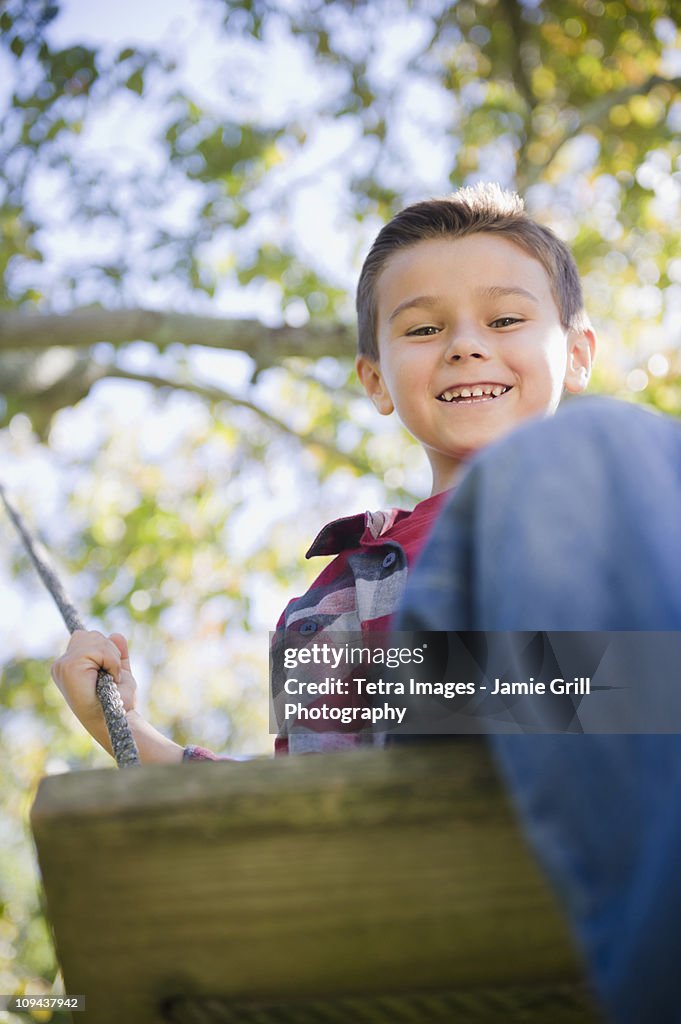 USA, New York, Flanders, Boy (8-9) playing in garden