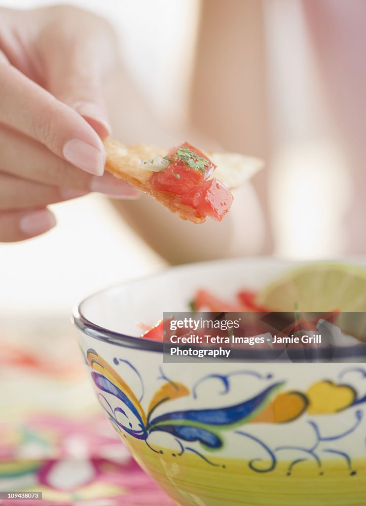 USA, New Jersey, Jersey City, Close-up view of woman's hand eating salad with cracker
