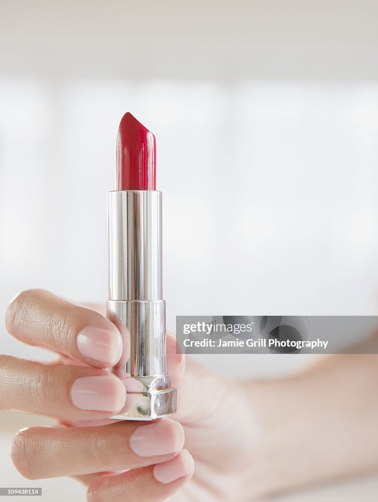 USA, New Jersey, Jersey City, Woman's hand holding lipstick