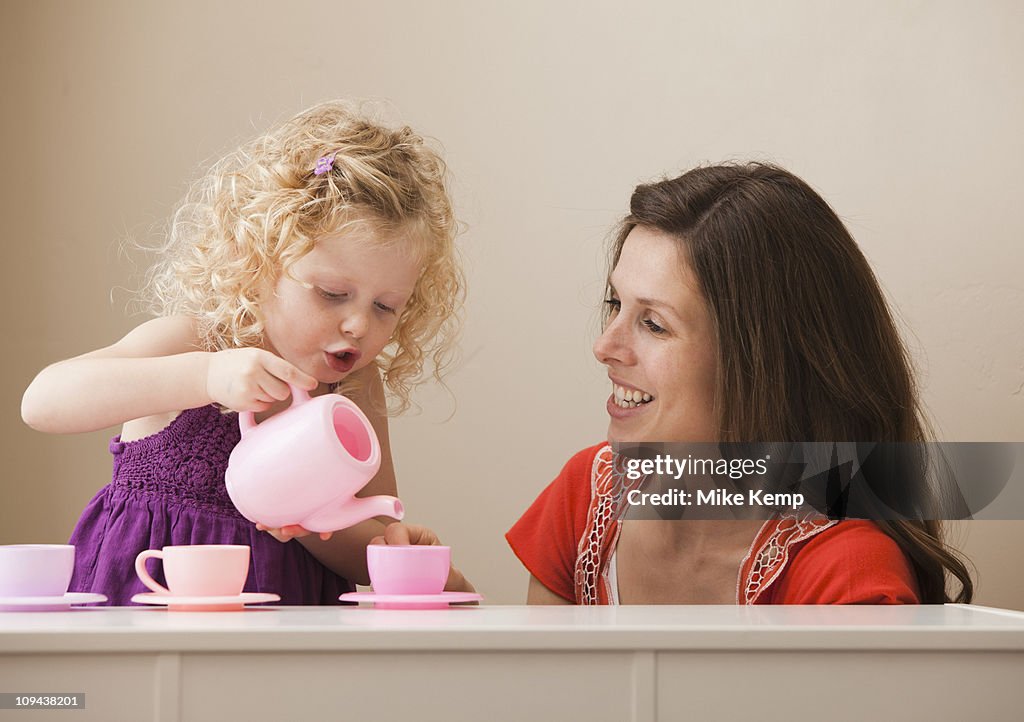 USA, Utah, Lehi, mother and daughter (2-30 having tea