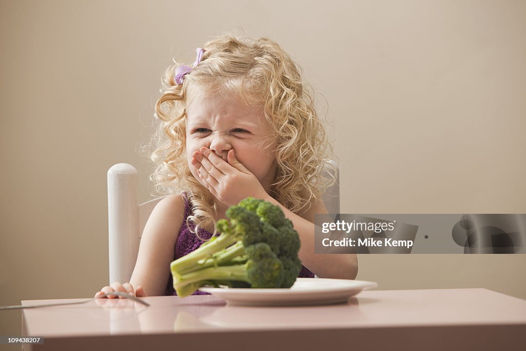 USA, Utah, Lehi, girl (2-3) disgusted with broccoli