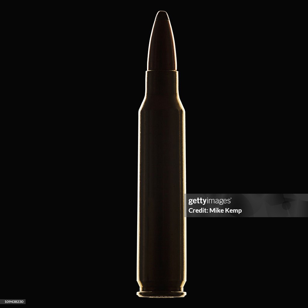 Single bullet on black background, close-up