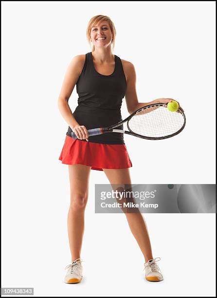 young woman holding tennis racket - tennis racquet isolated stock pictures, royalty-free photos & images