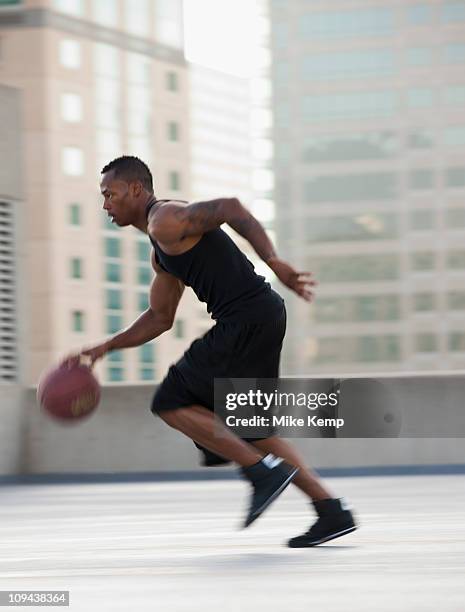 usa, utah, salt lake city, young man playing basketball - dribbling sport fotografías e imágenes de stock