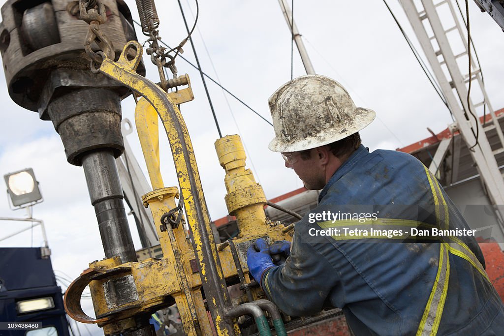 Oil worker drilling for oil on rig