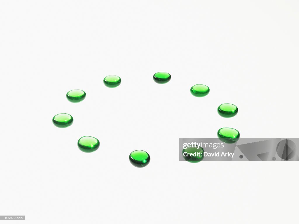 Studio shot of green glass beads in circle