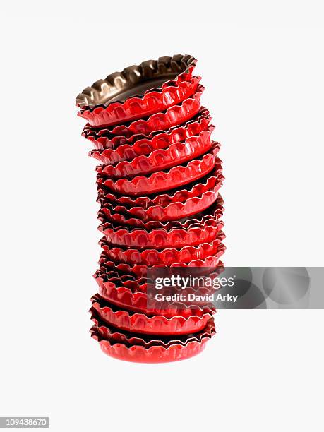 studio shot of heap of red bottle caps - bottle cap stock pictures, royalty-free photos & images