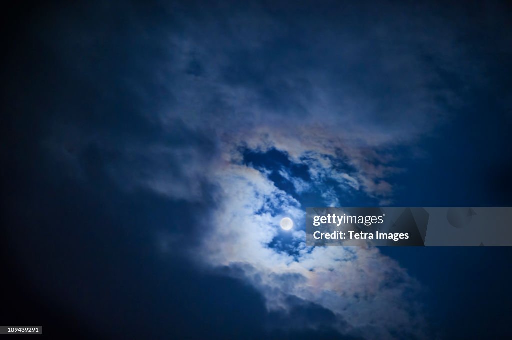 Full moon in cloudy sky at night