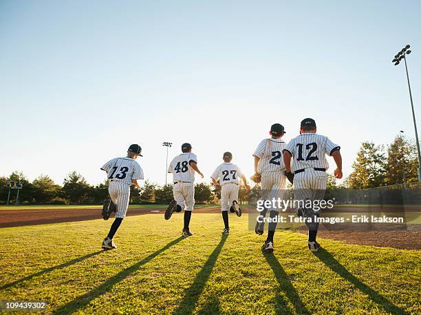 baseball players (10-11) running on baseball diamond - ungdomsliga för baseboll och softboll bildbanksfoton och bilder