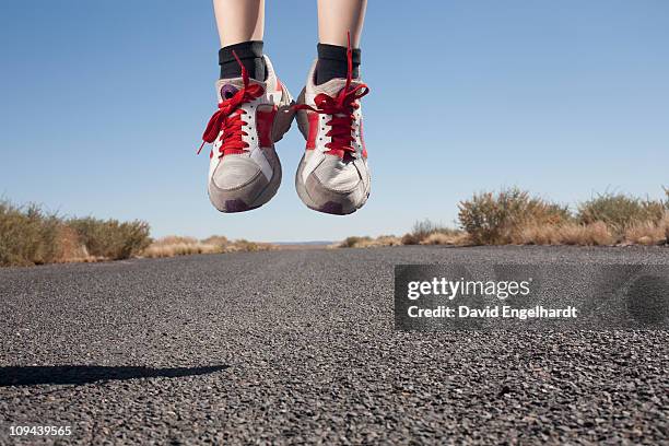 usa, arizona, winslow, human feet in sport shoes jumping - running shoes sky stock pictures, royalty-free photos & images