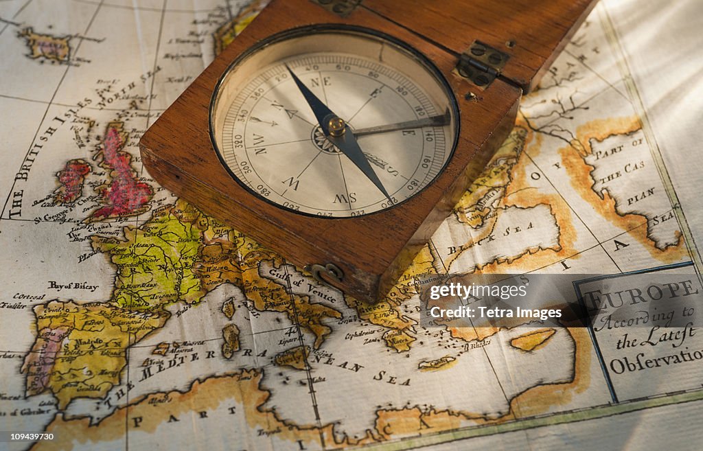 Antique compass on map