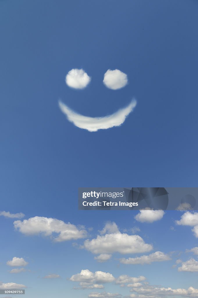 Clouds forming smiley face in sky