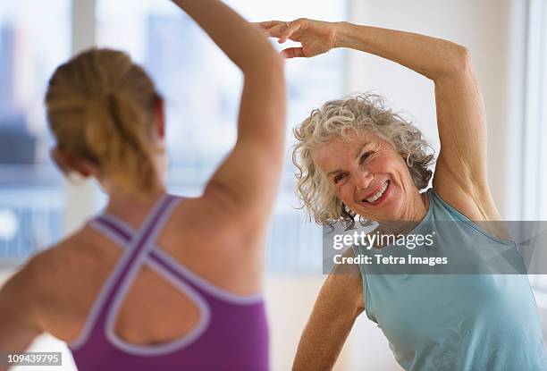 usa, new jersey, jersey city, senior woman with fitness instructor at gym - aerobics stock pictures, royalty-free photos & images