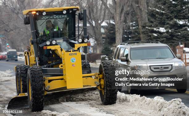 Road grader pushes snow away from the curb while a city crew removes snow on Ninth Avenue, between Sunset and Francis Streets, Thursday afternoon,...