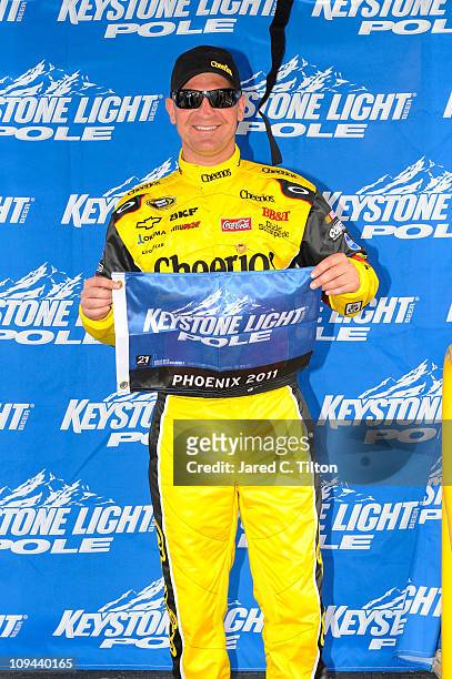 Clint Bowyer, driver of the Tide Chevrolet, poses after setting the pole position in qualifying for the NASCAR Camping World Truck Series Lucas Oil...