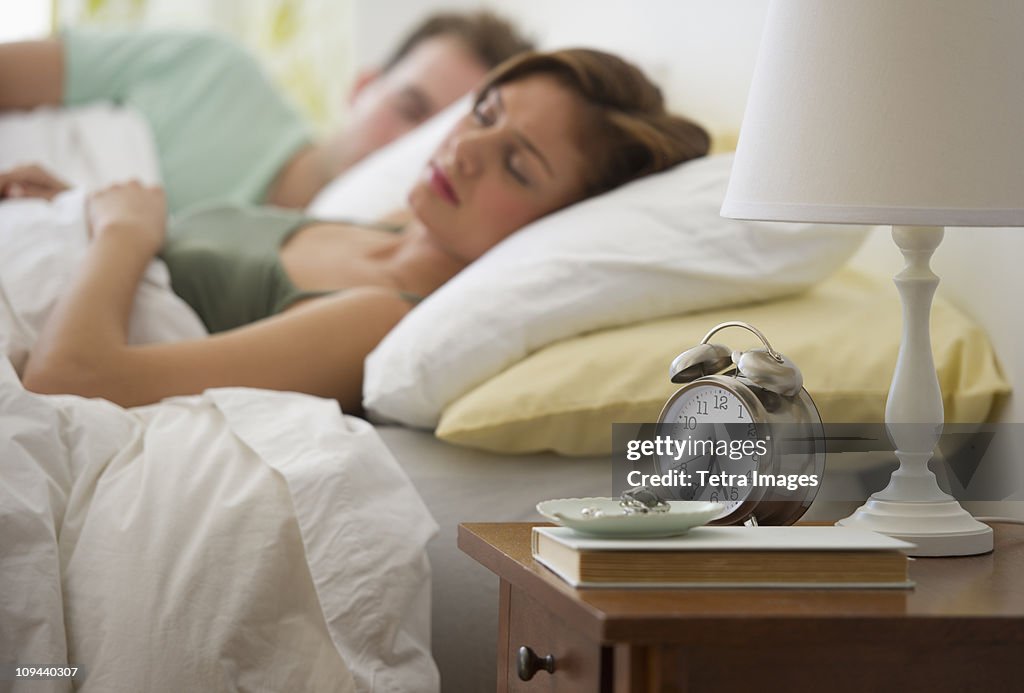 USA, New Jersey, Jersey City, Young couple sleeping in bed