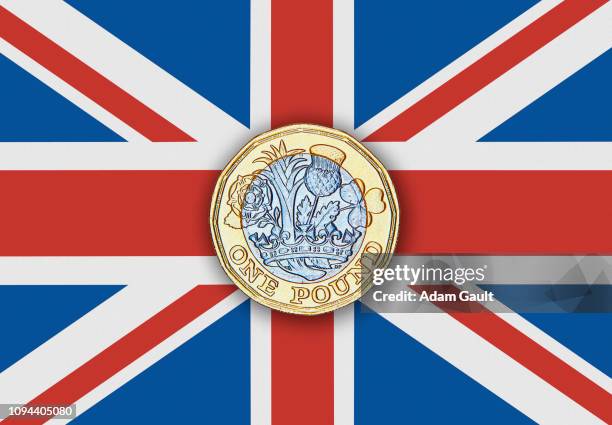 £1 one pound coin on uk union jack flag - pound coins stock pictures, royalty-free photos & images