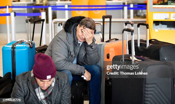 Passangers from Egypt wait between their luggage at Frankfurt Airport during a strike by security personnel on January 15, 2019 in Frankfurt,...