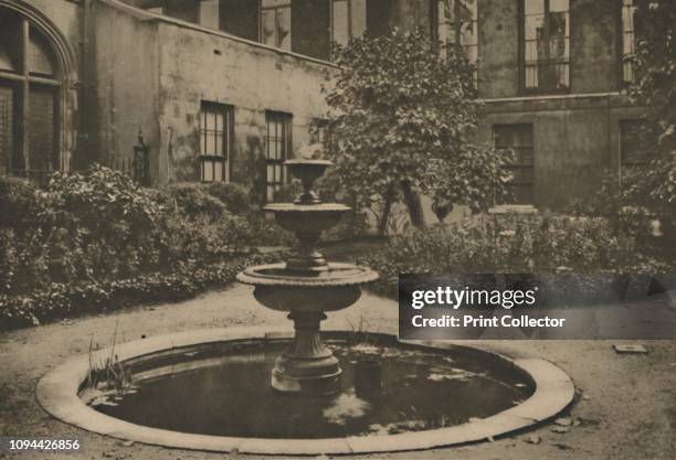 Ancient Mulberry Tree and Fountain in the Garden of Drapers' Hall', circa 1935. Courtyard of Drapers' Hall, belonging to the Worshipful Company of...
