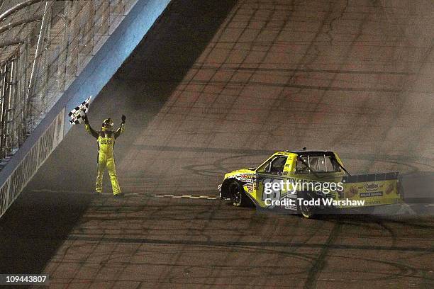 Kyle Busch, driver of the Dollar General Toyota, celebrates with the checkered flag after winning the NASCAR Camping World Truck Series Lucas Oil 150...