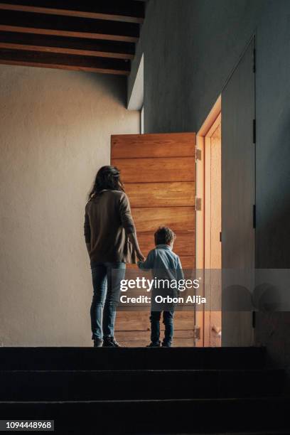 boy walking through the door - house closing stock pictures, royalty-free photos & images