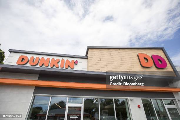 Signage is displayed on the exterior of a Dunkin' location in Quincy, Massachusetts, U.S., on Wednesday, June 20, 2018. Dunkin' Brands Group Inc. Is...