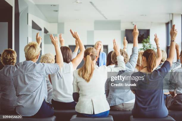 audience voting during seminar - democracy uk stock pictures, royalty-free photos & images