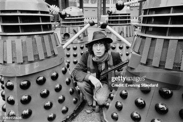 English actor Tom Baker as the 'Doctor' with Daleks on the set of British television series 'Doctor Who', UK, 5th March 1975.