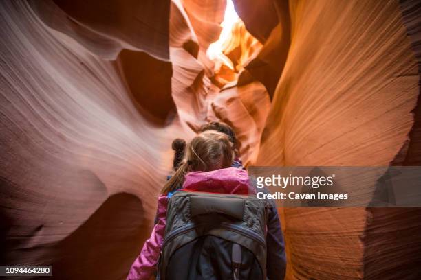 rear view of father carrying daughter while walking amidst rock formations at page - grand canyon - fotografias e filmes do acervo