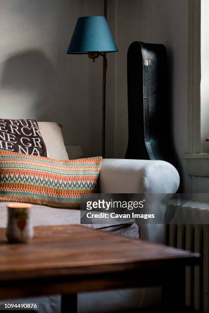 furniture with guitar case in living room at home - guitar case fotografías e imágenes de stock