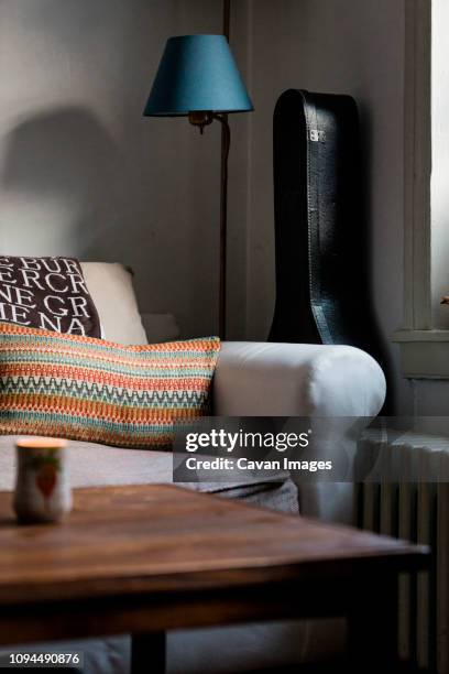 furniture with guitar case in living room at home - custodia per chitarra foto e immagini stock