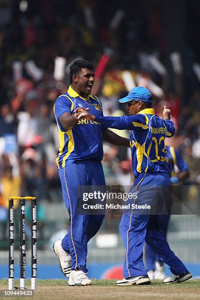 Thisara Perera of Sri Lanka celebrates with Thilan Samaraweera after taking the wicket of Ahmed Shehzad during the Pakistan v Sri Lanka 2011 ICC...