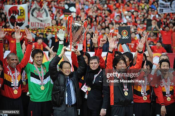 Nagoya Grampus players celebrate with Toyota Motor Corporation President Akio Toyoda and Nagoya Grampus head coach Dragan Stojkovic after winning the...