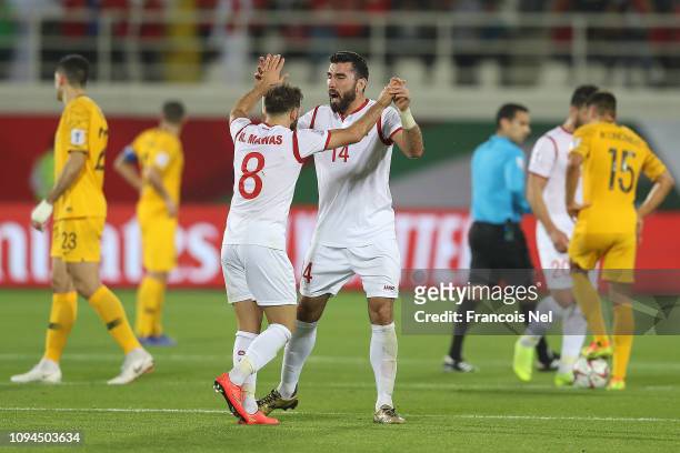 Tamer Hag Mohamad and Mahmoud Almawas of Syria celebrate the equalising goal during the AFC Asian Cup Group B match between Australia and Syria at...