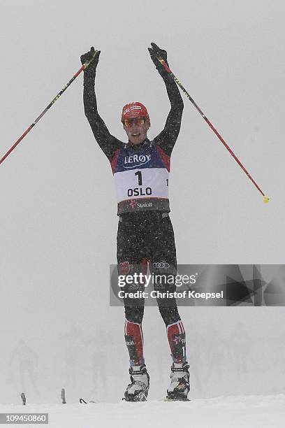 Eric Frenzel of Germany celebrates winning the gold medal as he crosses the finish line in the Nordic Combined Individual 10KM Cross Country race...