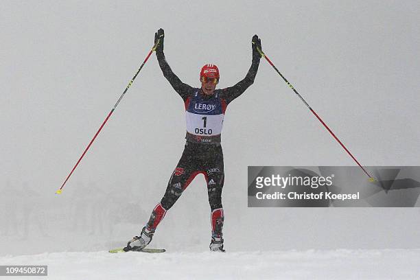 Eric Frenzel of Germany celebrates winning the gold medal as he crosses the finish line in the Nordic Combined Individual 10KM Cross Country race...