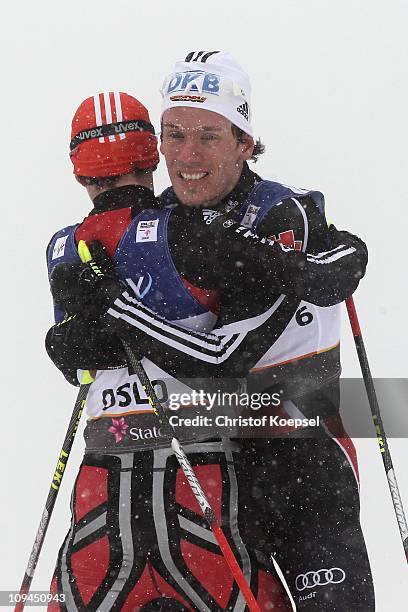 Medallists Eric Frenzel and Tino Edelmann of Germany celebrate following the Nordic Combined Individual 10KM Cross Country race during the FIS Nordic...