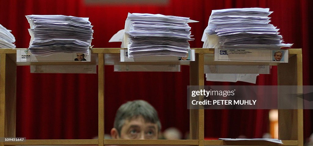 An election official looks at the stack