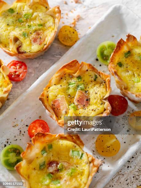 crispy baked wonton egg cups with bacon, cheddar cheese and green onions - egg cup stock pictures, royalty-free photos & images