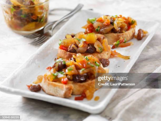 apple and ginger chutney with raisins on a crostini - homemade apple sauce stock pictures, royalty-free photos & images