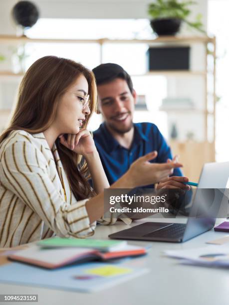 young woman working with partner - friendly small business talking stock pictures, royalty-free photos & images