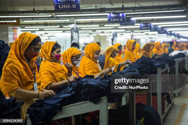 Workers at a garment factory work at MB Knit garment factory in Narayanganj, near Dhaka.