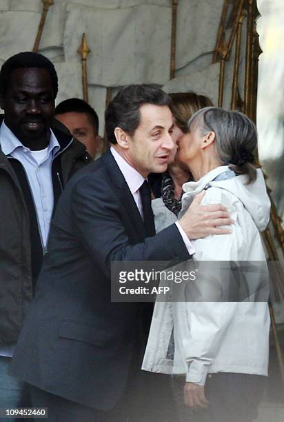 French president Nicolas Sarkozy escorts freed French hostages, Françoise Larribe and Togo's Alex Kodjo Ahonado after a meeting at the Elysee Palace...