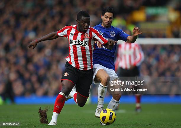 Sulley Muntari of Sunderland is challenged by Mikel Arteta of Everton during the Barclays Premier League match between Everton and Sunderland at...