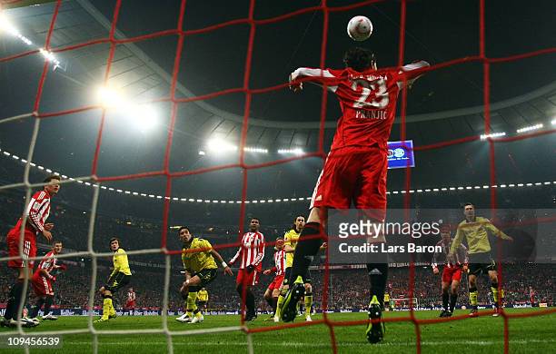 Mats Hummels of Dortmund heads his teams third goal over Danijel Pranjic of Muenchen during the Bundesliga match between FC Bayern Muenchen and...